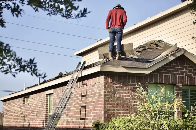 Professional roofer working on a residential roof in Arrowhead Trails
